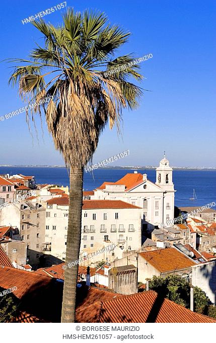 Portugal, Lisbon, roofs of Alfama District and Santo Estevao St Stephen Church seen from the terrace of Largo das Portas do Sol