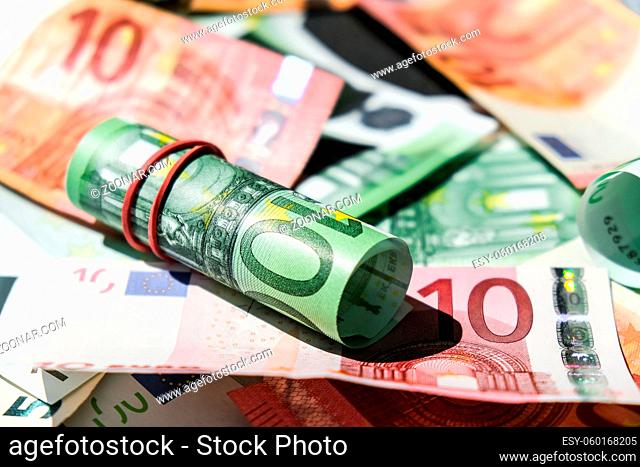 Close up of Euro money roll. Euro banknote set cash money - EU currency. Rolled with rubber euro notes. Business budget of wealth and prosperity finance