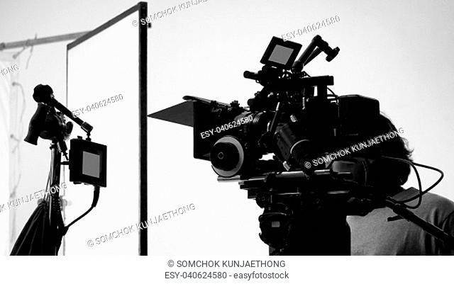 Movie shooting or video filming production by crew team and professional equipment such as super ultra high definition digital camera with tripod and lighting...