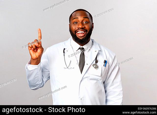 Portrait of cheerful african-american male doctor explain one simple task for patient stay healthy, not getting covid19, make daily check-up in hospical