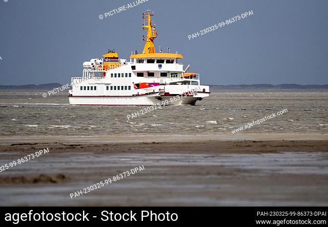 25 March 2023, Lower Saxony, Bensersiel: The ferry ""Langeoog IV"" is underway in changeable weather on the North Sea in the Wadden Sea