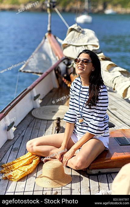 Young woman with sailor clothes, Sailing boat, Pasaia port, Gipuzkoa, Basque Country, Spain, Europe