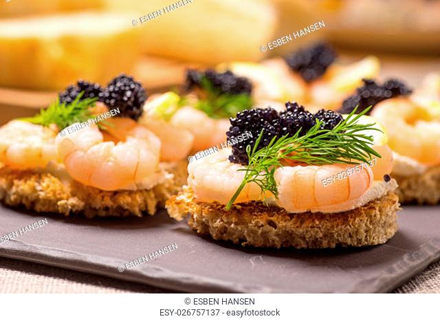 Shrimp Appetizer served on toasted bread and served on a slate plate