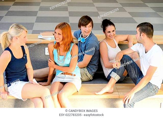 Students talking sitting on school bench
