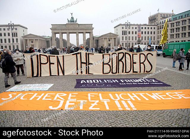 14 November 2021, Berlin: ""Open the borders"" is written on a banner at a demonstration for the immediate admission of migrants at the Polish-Belarusian border