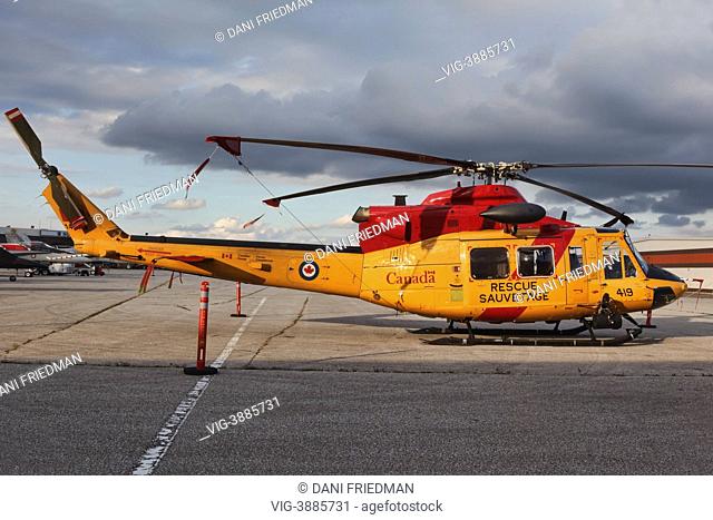 CANADA, MISSISSAUGA, A Canadian Forces Bell CH-146 Griffon search and rescue helicopter outside a hangar after the Toronto International Air Show in Mississauga