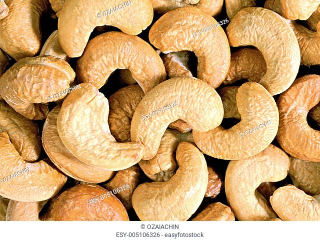 Unshelled roasted cashew nuts isolated on white, food background