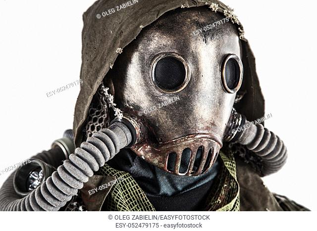 Close up portrait of nuclear post-apocalypse survivor, living underground mutant or creature, skilled stalker wearing rags and armored full-face gas mask or air...