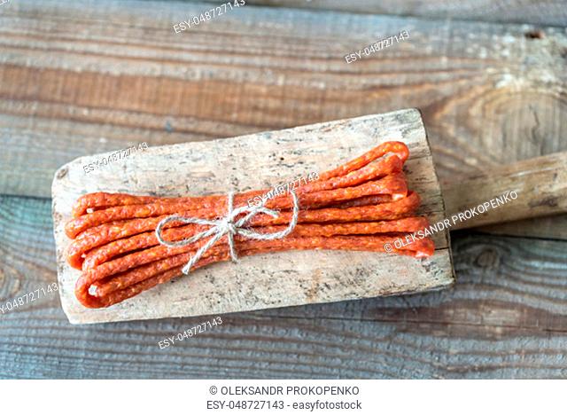 Smoked sausages on the wooden background