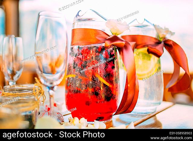 Decanters with fruit lemonade on the table at the wedding in Montenegro