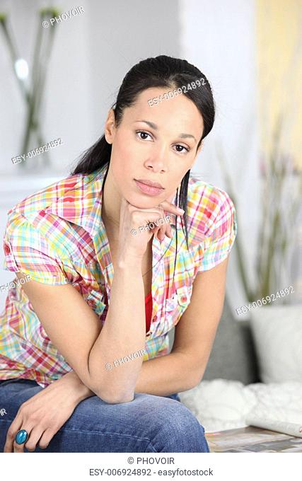 Bored woman sat on sofa