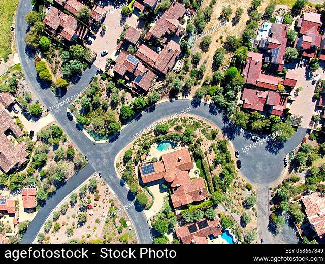 Aerial view of big luxury villa with pool located next the golf course and green valley in a private community, San Diego, California