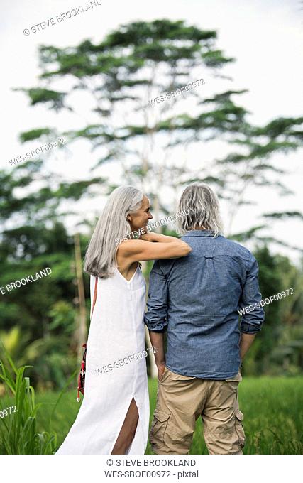Senior couple looking at tropical landscape