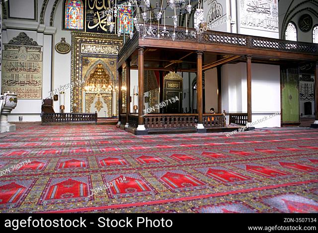 Carpet and mihrab inside mosque Eski Jami in Bursa, Turkey