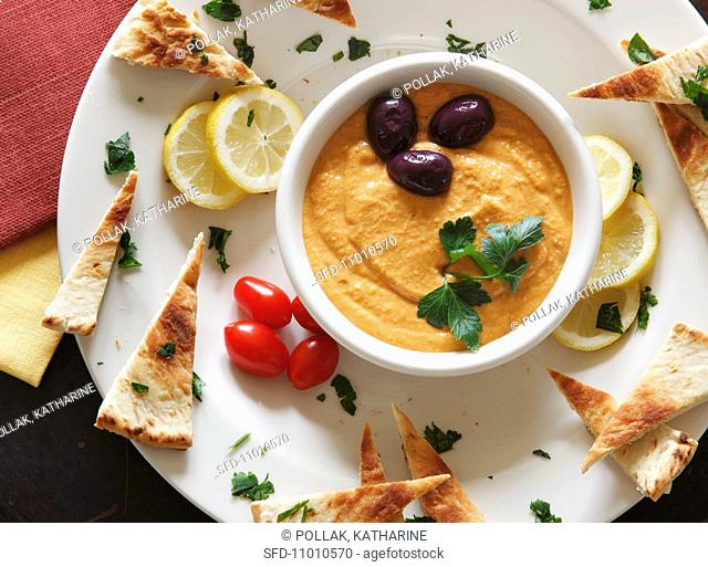 A Plate of Hummus and Toasted Pita Bread Triangles, From Above