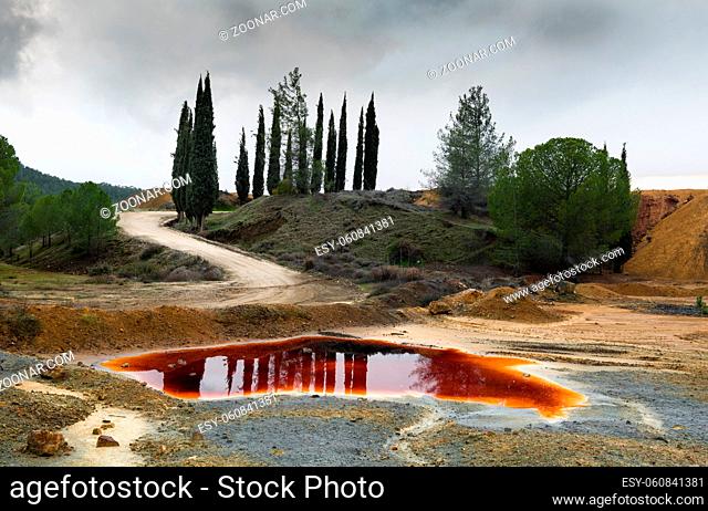Lake with red polluted toxic water of an Abandoned copper mine at Mitsero area in Cyprus