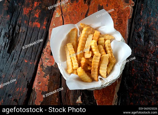 French fries isolated on rustic wooden table