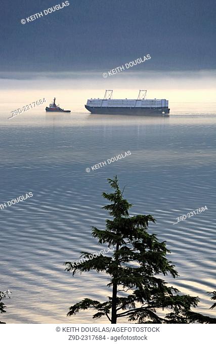 Tugboat and bulk cargo barge heading for Alcan aluminum smelter, Kitimat, British Columbia