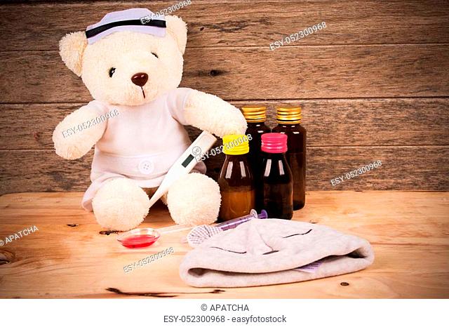 White teddy bear wear nurse with thermometer and medicine