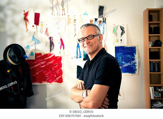 Confident entrepreneur, portrait of happy mature man working as fashion designer and dressmaker in atelier