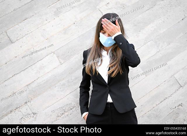 Sick young businesswoman wearing face mask, . Ill female worker having coronavirus, flu infection symptom concept. High quality photo
