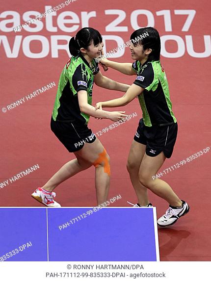 Japan's Hina Hayata (L) and Miu Hirano (R) celebrate after their 3-0 victory at the finals of the Women's double at the Table Tennis German Open match between...