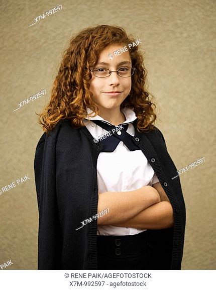 School age mixed race Mexican & caucasian girl with glasses in school uniform