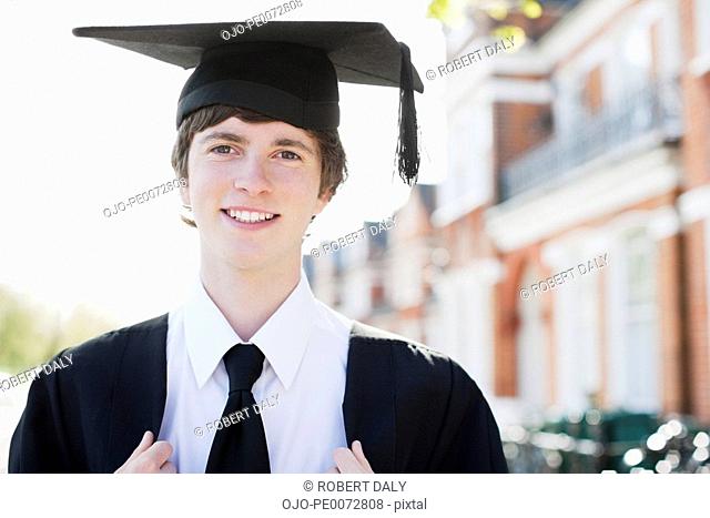 Smiling boy wearing cap and gown