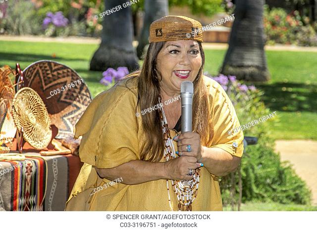 Wearing authentic tribal costume, a women member of the Acajachemen Native American tribe lectures on tribal customs and craftsmanship at the famous mission in...