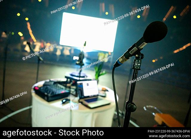 20 December 2023, Hamburg: Microphones, sound and image technology are set up in front of a screen before the event. Almost 100 very different people have...
