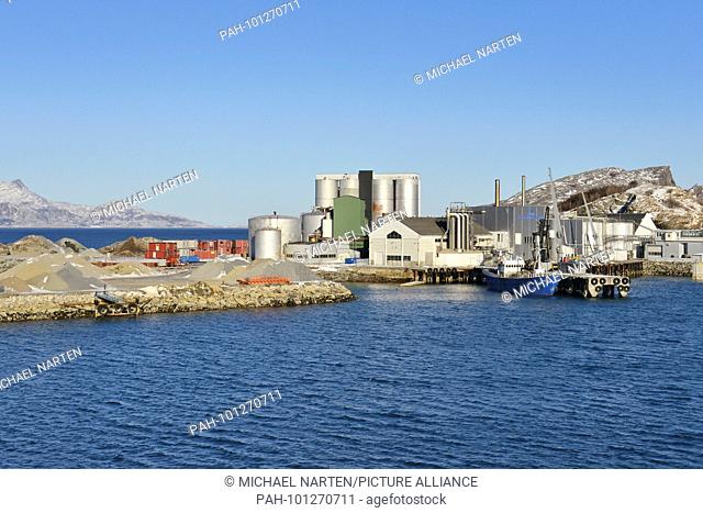Industrial park at the shore of Bodø's harbour with silos and containers and a pier with a blue ship, 5 March 2017 | usage worldwide