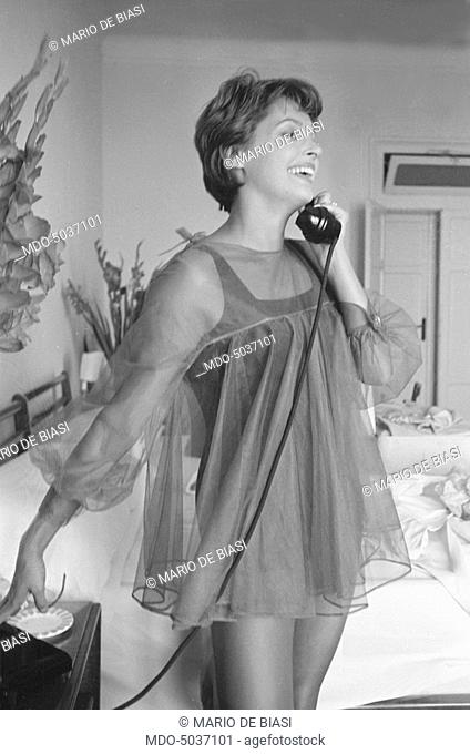 Austrian actress Nadja Tiller speaking over the phone in night gown during the 19th Venice International Film Festival. Venice, August 1958