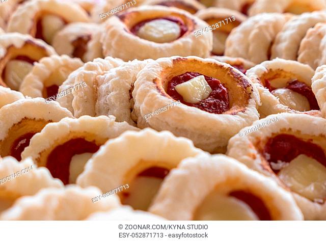 Group of Small pizzas with mozzarella and tomato. Traditional and famous Italian plate. In particular, mini pizzas, are used as aperitifs in parties and events