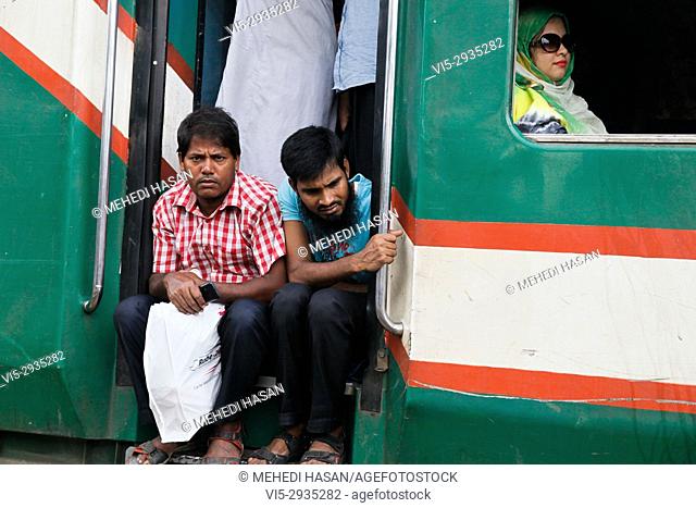 Bangladeshis cram onto a train as they travel home to be with their families ahead of the Muslim festival of Eid al Fitr, in Dhaka