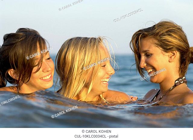 Girls teenagers playing in the sea