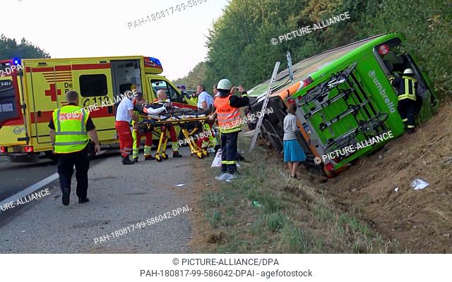 dpatop - 17 August 2018, Germany, Linstow: Paramedics on the A19 Rostock-Berlin attend to injured people in a bus accident