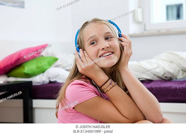Smiling girl listening to headphones