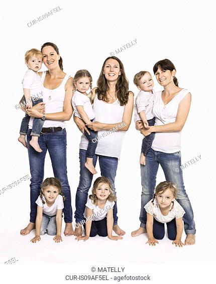 Studio portrait of three mid adult mothers and six children