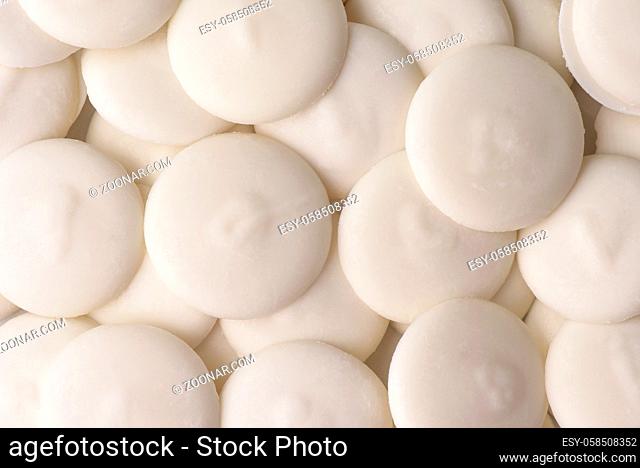 Top view of white chocolate buttons background