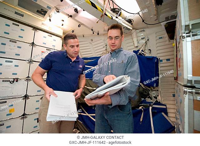 Astronaut George Zamka (left), STS-130 commander, participates in an ingressegress timeline training session in a shuttle mock-up in the Space Vehicle Mock-up...