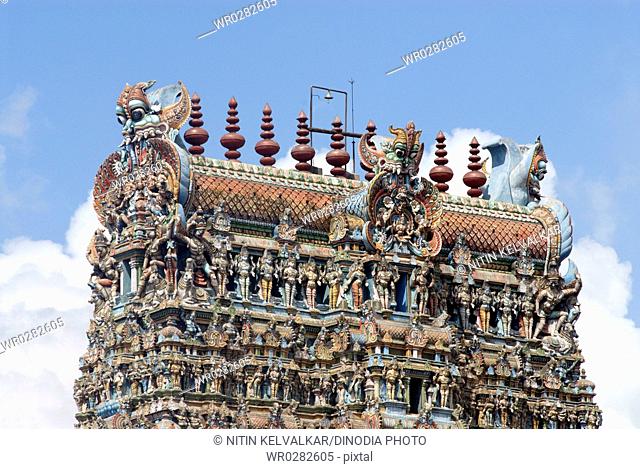 Richly decorated and Colourfully painted stucco figures on gopuram of Shree Meenakshi Sundareswara temple , Madurai , Tamil Nadu , India