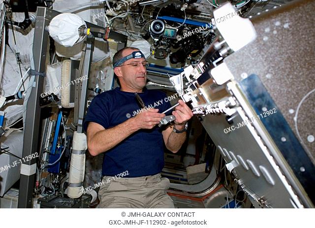 Astronaut Donald Pettit, STS-126 mission specialist, installs the Combustion Integrated Rack (CIR) in the Destiny laboratory of the International Space Station...