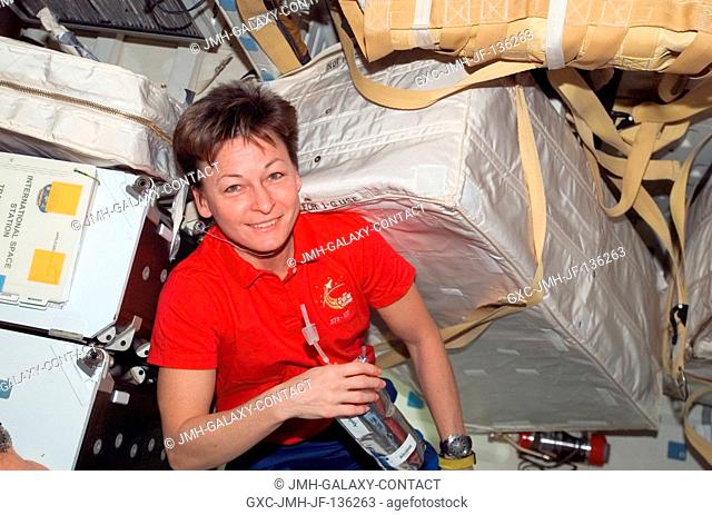 Astronaut Peggy Whitson, Expedition 16 commander, holds a beverage on the middeck of Space Shuttle Atlantis (STS-122) while docked with the International Space...