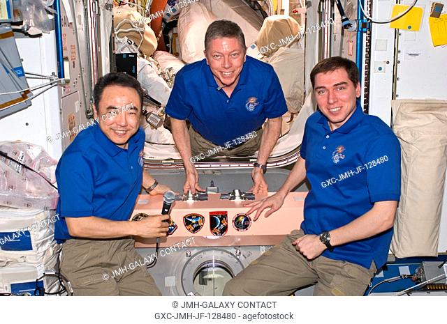 In the Unity node, Expedition 29 crew members pose for a photo after adding the Expedition 29 patch to the growing collection of insignias representing crews...