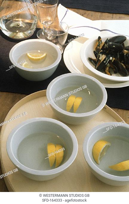 Finger bowls with lemon water for eating mussels