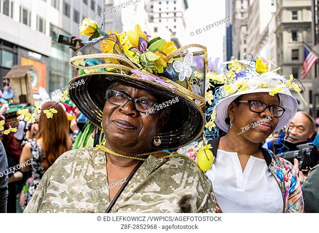New York, NY - April 16, 2017. A woman with an elaborate hat with decorations of flowers and butterflies at New York's annual Easter Bonnet Parade and Festival...