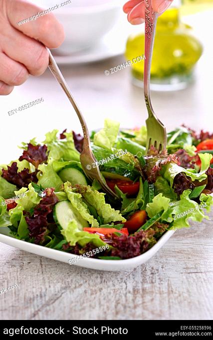 Vegetarian food. Detox vegetable salad - Lettuce, tomato, cucumber seasoned lemon-olive gravy. A dish for those who monitor their health