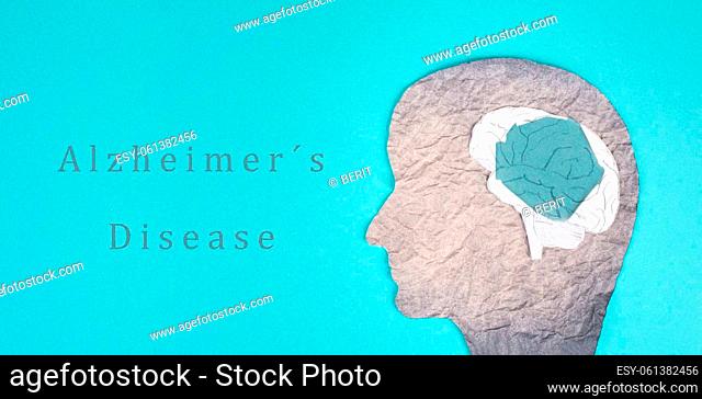 Alzheimer disease is standing on a paper, silhouette of a head with a damaged brain, dementia diagnosis, Parkinson's awareness day