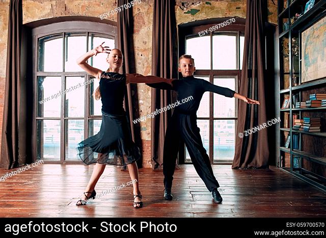 Young couple boy and girl dancing in ballroom dance Rumba