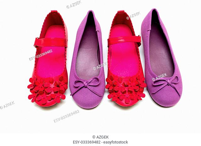 Children's bright purple and pink shoes on a white background